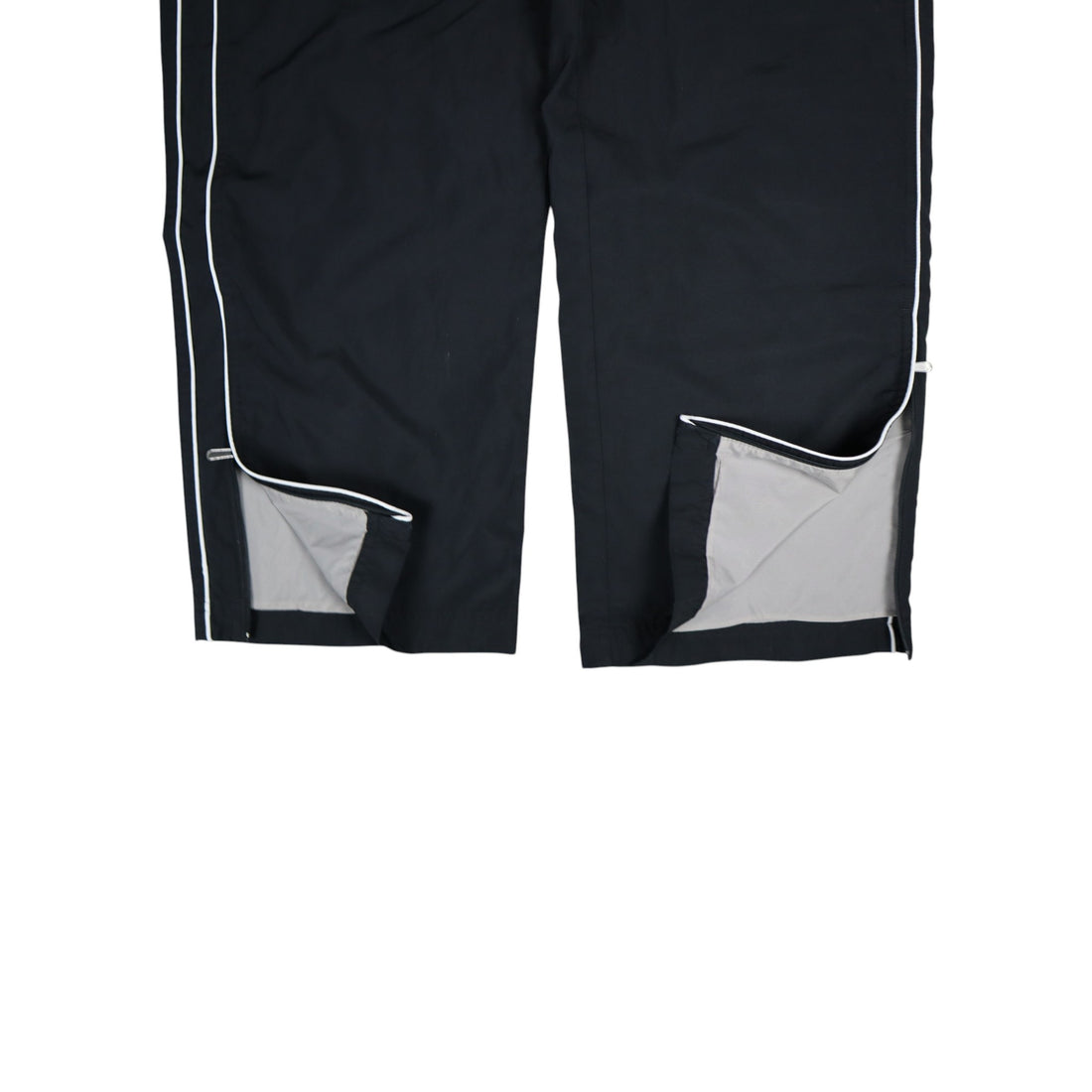 2000s Nike trackpants in black with white stripes — flat lay