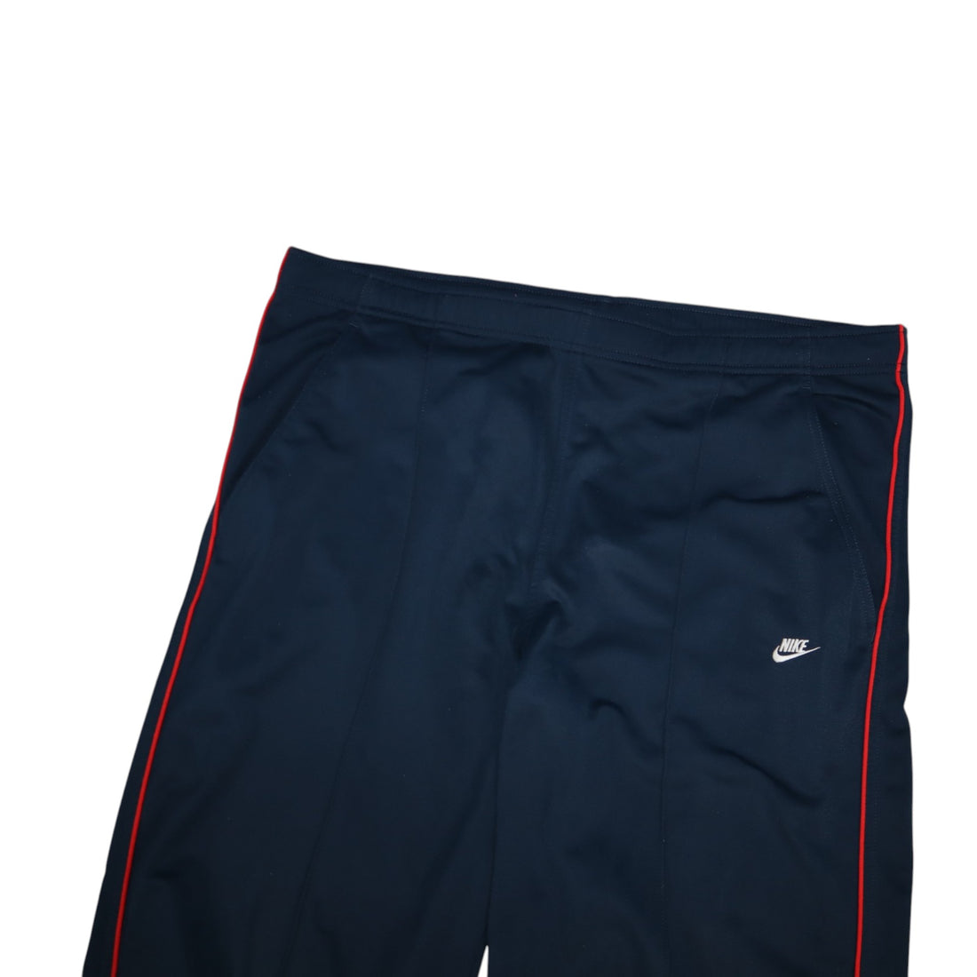 2000s Nike trackpants in navy with red stripes — flat lay