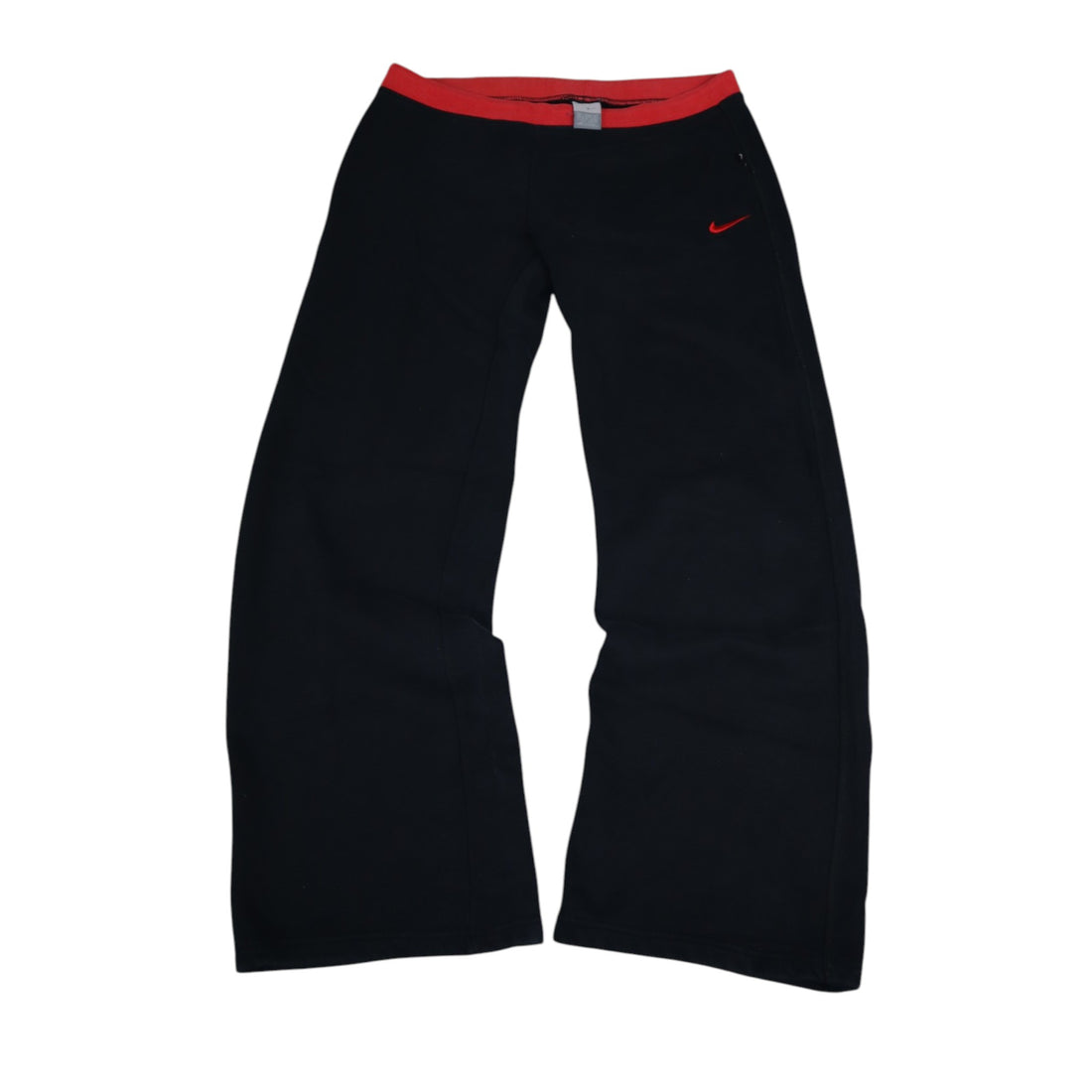 2000s Nike trackpants in black with red details — flat lay